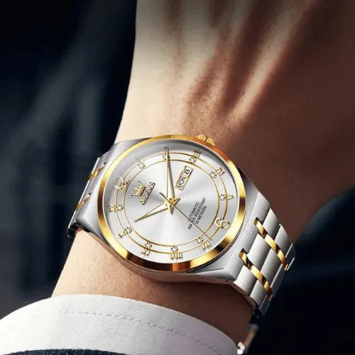 Gold and white automatic wristwatch featuring sapphire glass, luminous hands, and stainless steel strap.