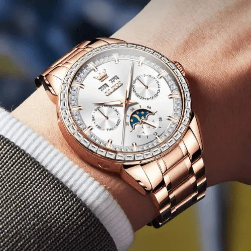 Rose gold automatic men’s watch with white dial, moon phase and calendar, shown elegantly on wrist.