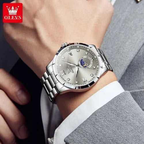 Elegant OLEVS men’s business quartz watch with silver dial and moon phase, worn with suit.