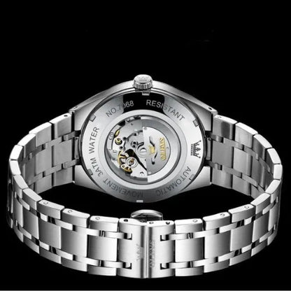 Men’s automatic timepiece with classic white dial, golden details, and transparent case back mechanism.