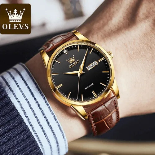 Business-style OLEVS men’s wristwatch with black dial, gold case and brown leather strap on wrist.