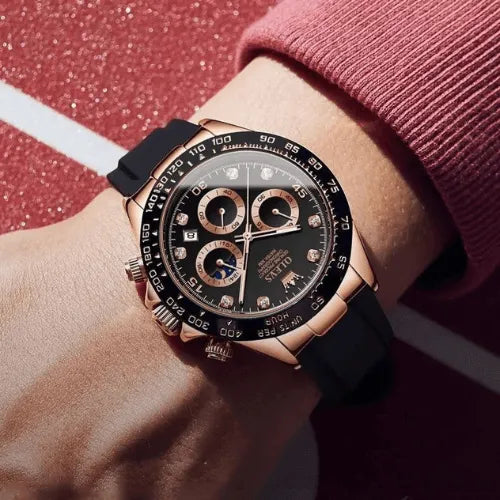 OLEVS Dominant Chronograph Black Rose watch worn on wrist, featuring rose gold case, black dial with luminous hands, and sporty black silicone strap.