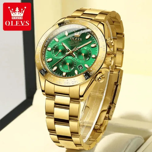 Close-up of men’s automatic luxury watch with gold case, green dial and luminous hands, displayed at an angle.