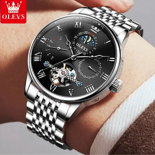 Silver Black men’s luxury automatic watch with stainless steel bracelet, tourbillon mechanism and waterproof design, worn on wrist.