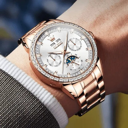 Rose gold automatic men’s watch with white dial, moon phase and calendar, shown elegantly on wrist.