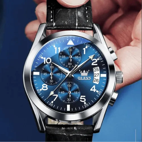 Premium OLEVS men’s chronograph watch featuring blue dial, luminous markers and multifunction design held in hand.
