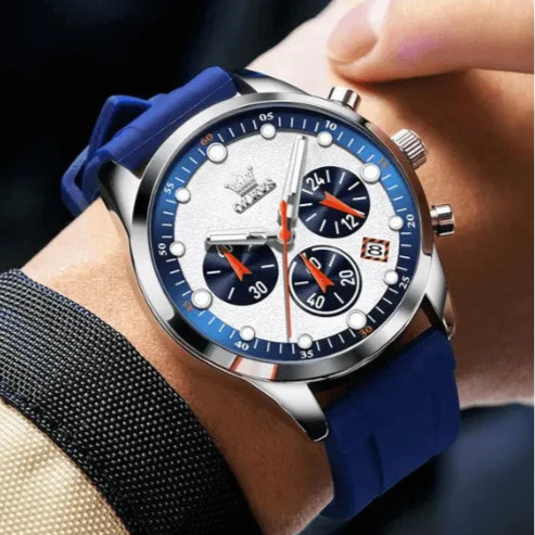 OLEVS chronograph watch with blue strap shown on a man’s wrist.