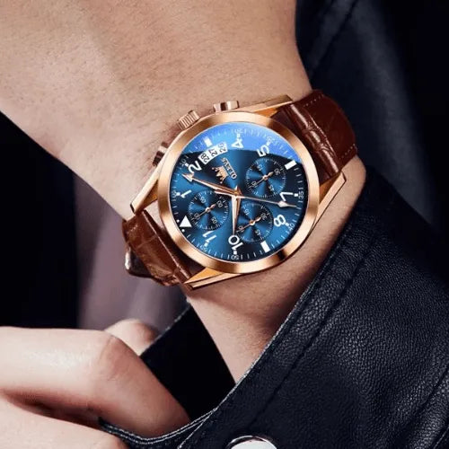 Elegant OLEVS  gold chronograph watch with blue dial and brown leather strap worn on wrist.