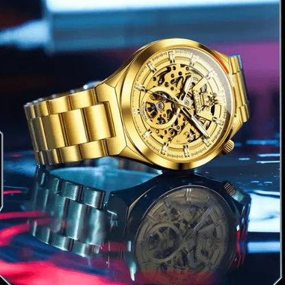 Stylish OLEVS gold skeleton automatic men’s watch photographed on reflective surface highlighting golden bracelet.