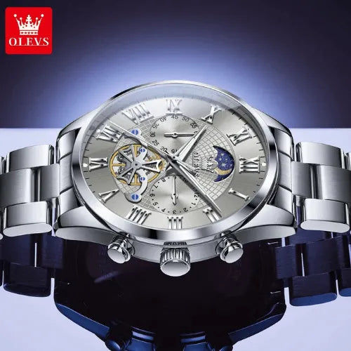 Detailed view of OLEVS silver men’s chronograph watch with moon phase dial and sub-dials.