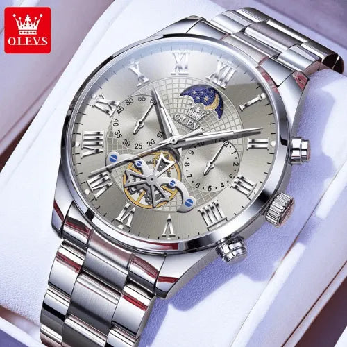 OLEVS men’s stainless steel silver moon phase watch displayed on cushion with polished bracelet.