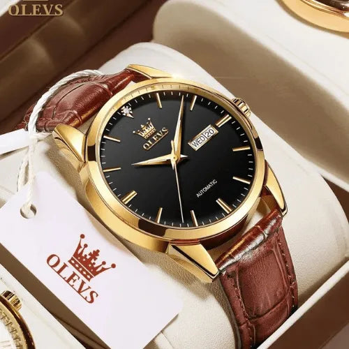 Luxury OLEVS men’s watch with black dial, day-date display and brown leather strap in presentation box.