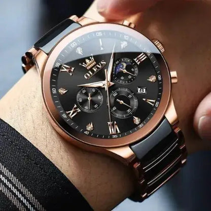 Refined OLEVS Regal Chronograph Rose Gold Edition watch displayed on wrist, featuring a black dial with gold Roman numerals, three sub-dials, moon phase indicator, date window, and a rose gold and black stainless-steel bracelet