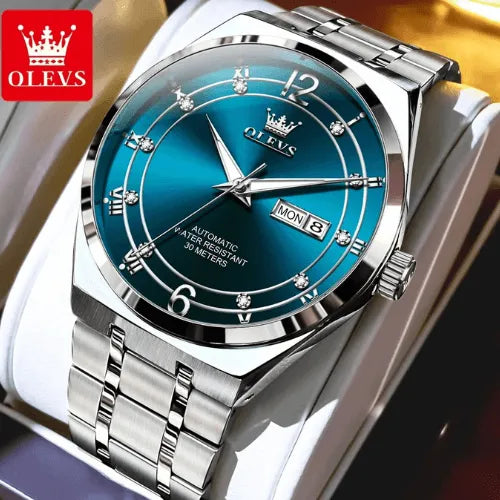 Elegant silver automatic watch with blue dial and stainless steel strap.