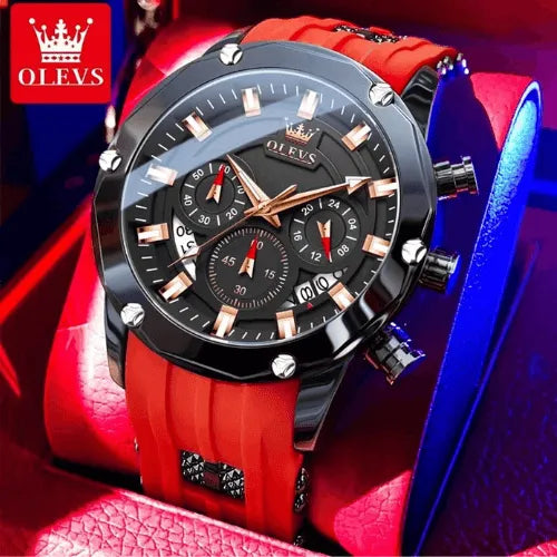 Luxury men’s chronograph Flame Racer with black dial, red silicone strap and gold markers, displayed in a red box.
