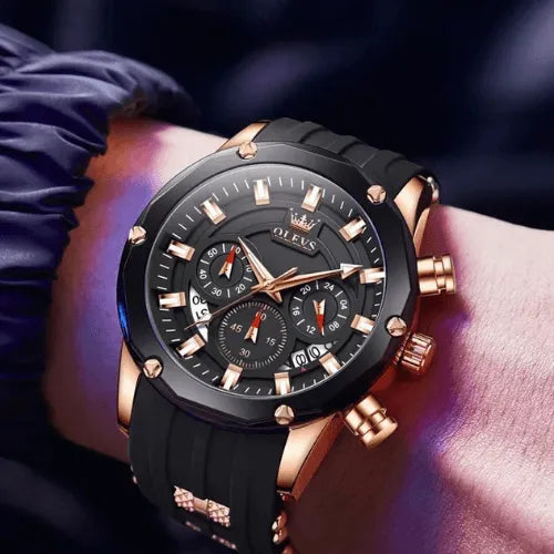 Men’s chronograph Night Force watch in black and gold with silicone strap, worn on wrist.