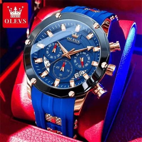 Luxury men’s chronograph watch with blue dial and silicone strap displayed in a red case.