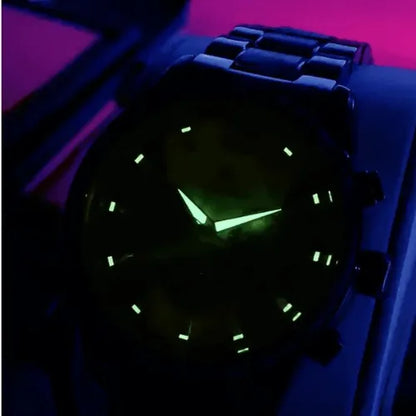Night view of men’s chronograph watch with luminous hands and hour markers glowing in the dark.