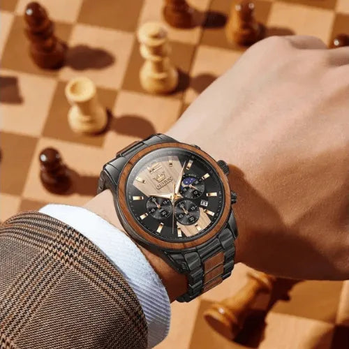 Gentleman wearing a luxury chronograph watch with wood and steel bracelet.