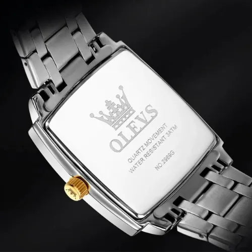 Close-up of OLEVS men’s square stainless-steel watch case back showing 3 ATM water resistance and quartz movement.