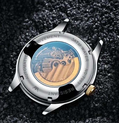 Mechanical movement back view of OLEVS automatic silver and gold men’s watch.