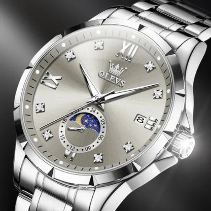 Close-up of OLEVS business quartz men’s watch featuring silver dial, diamond markers and moon phase.