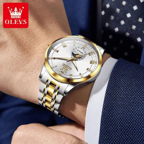 Silver and gold OLEVS automatic wristwatch for men worn with blue suit.