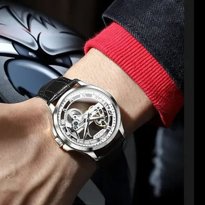 Men’s skeleton mechanical watch with black leather strap worn on wrist.